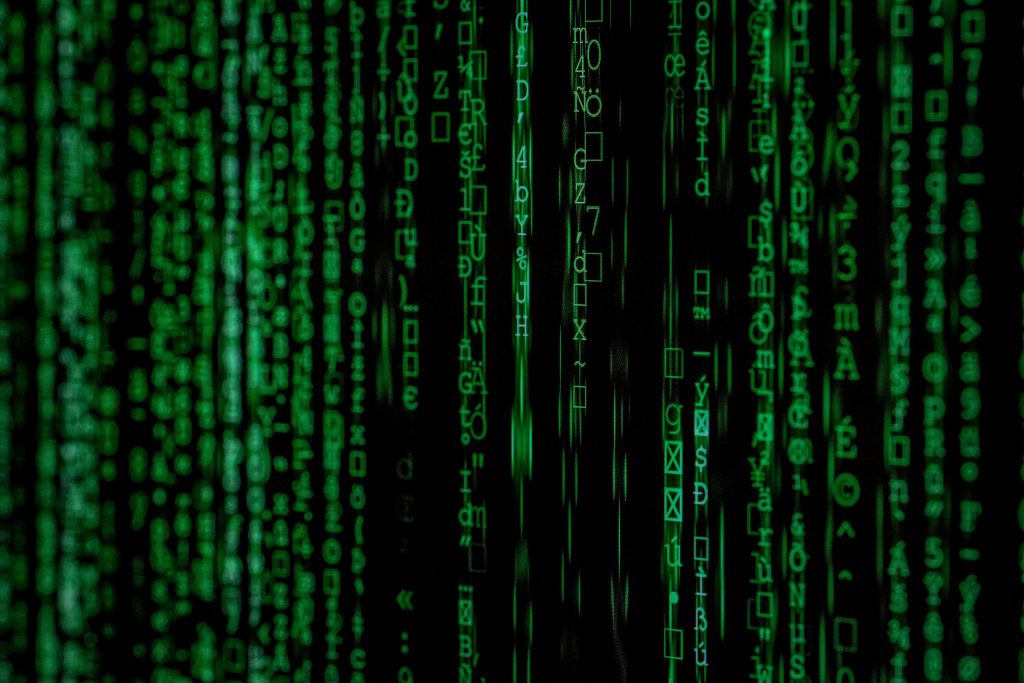 pexels-photo-1089438-1089438 Abstract green matrix code background with binary style.